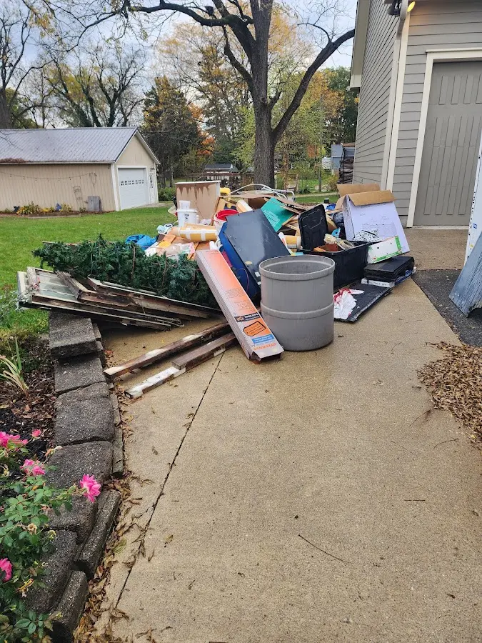 Dumpster being loaded with debris for 3 Yard Dumpster Rental in Bothell